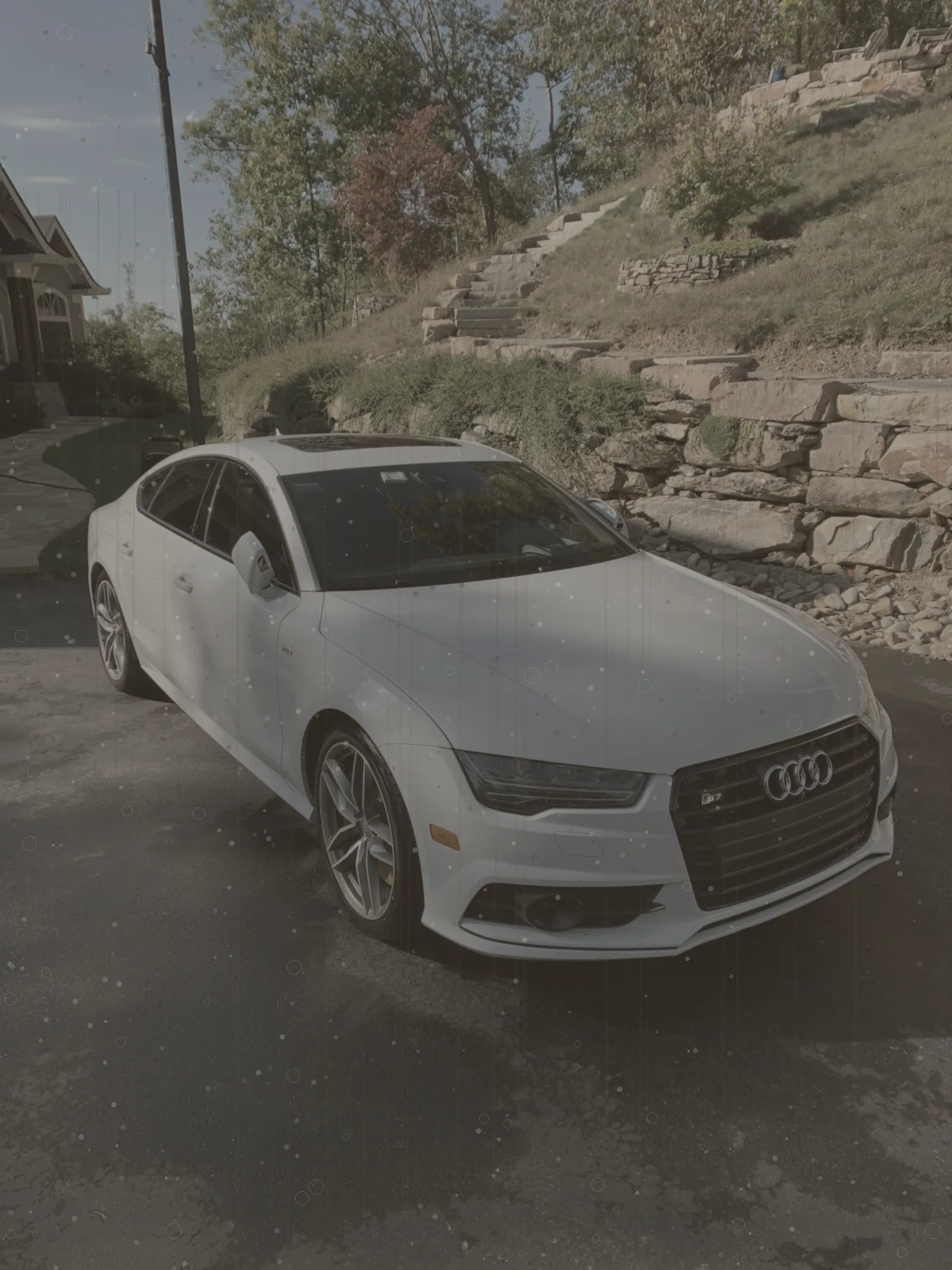 White sport sedan with dull, hazy paint before exterior detailing