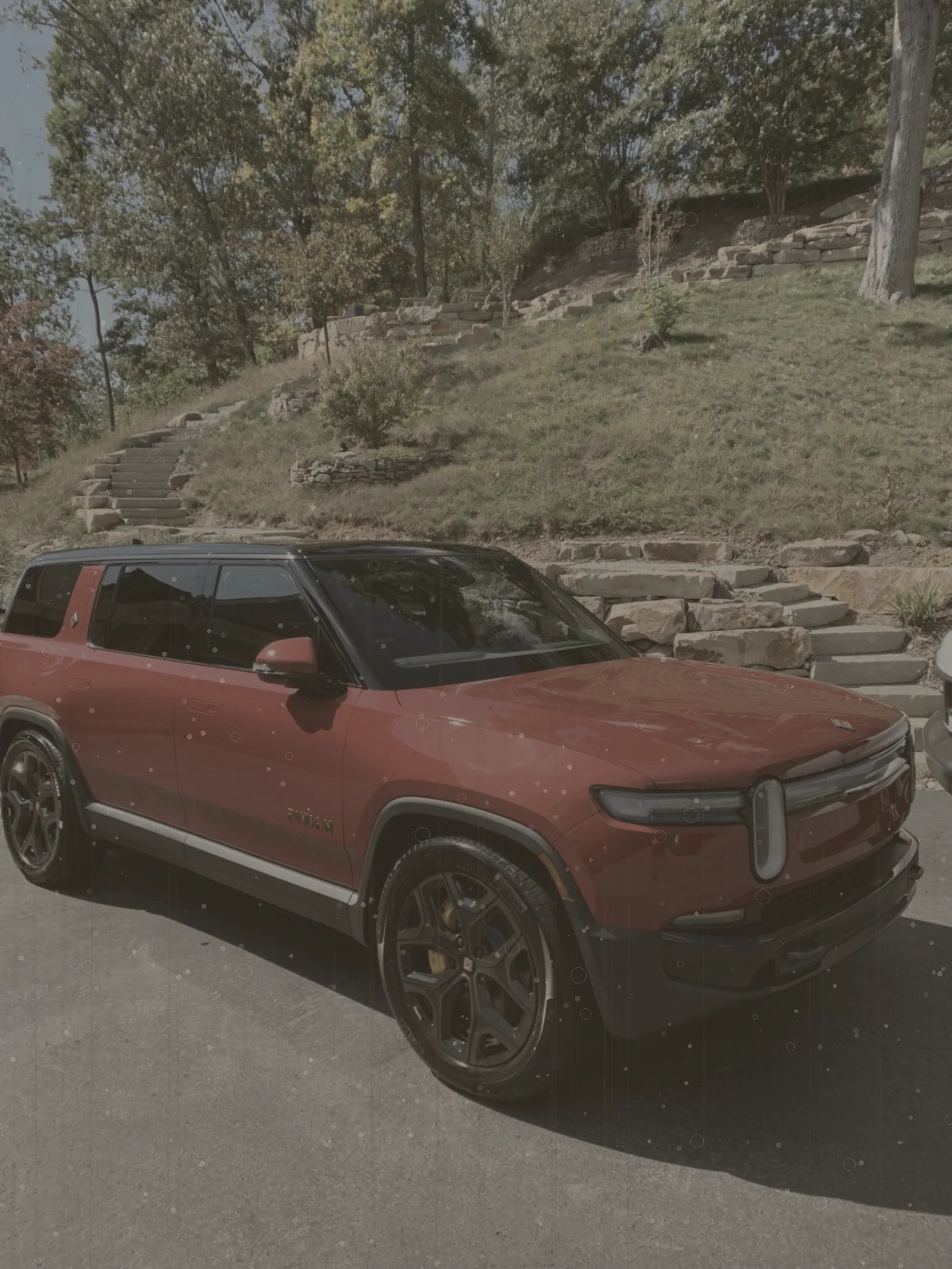 Red adventure SUV coated in trail dust before detailing