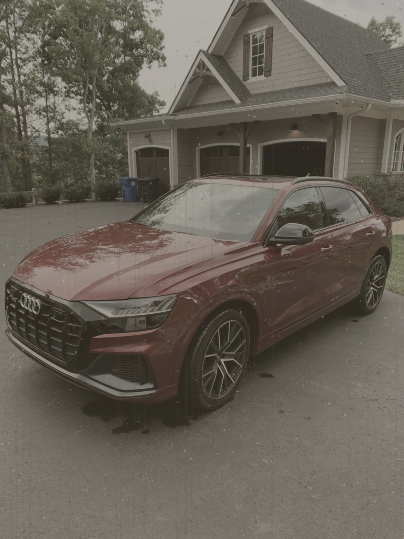 Red SUV dulled by dirt and water spots before detailing